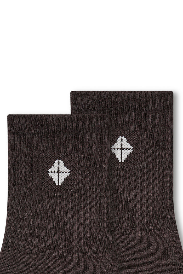 Top part of Adult Crew Socks in Espresso with Kyte Baby logo on a white background