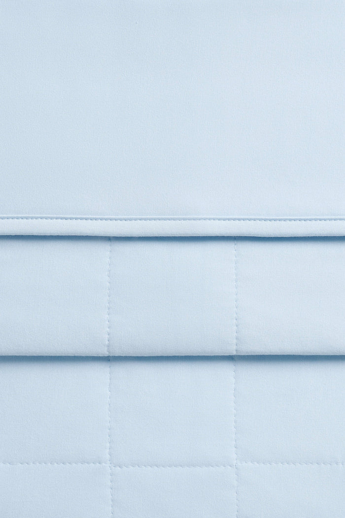 Close up of the Adult Quilted Blanket in Breeze 2.5 showing the quilted backing and smooth top