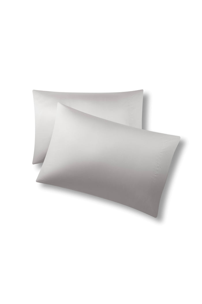 Two pillows one on top of the other with the Bamboo Sateen Pillowcases in Dove Gray on them