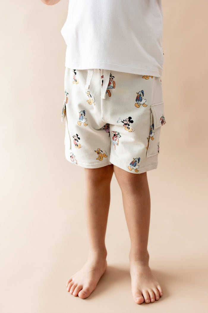 Close up of child wearing mickey mouse and friends printed cargo shorts