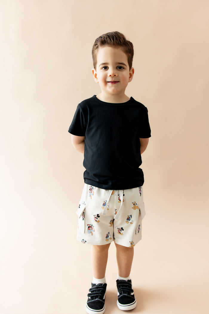 Boy wearing black tshirt and mickey mouse and friends printed cargo shorts