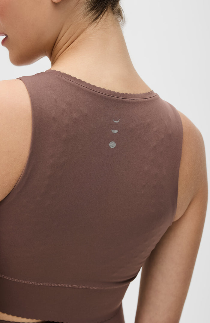 Brown  Elastique Athletics tank top with subtle design on a plain background
