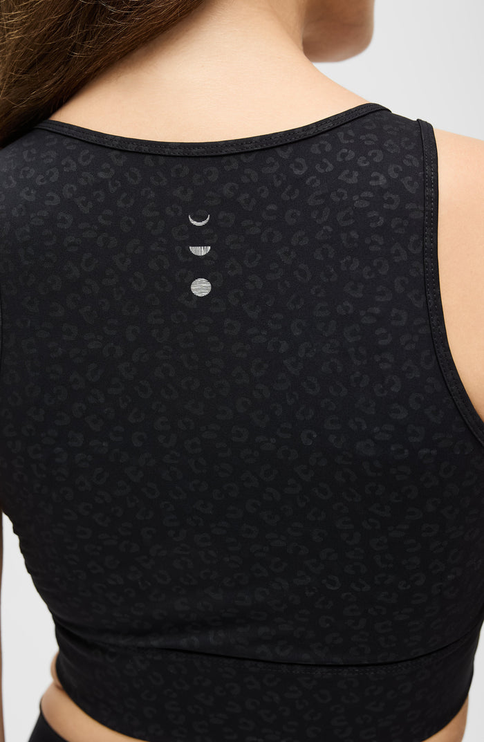 Back detail of the Elastique Athletics The Fierce Bra in black highlighting the racerback design and centered logo detail.