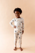 Smiling child posing wearing the Long Sleeve Pajamas in Fluffy Cat