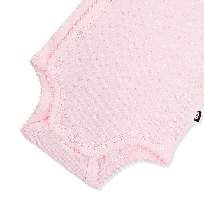 Snap closures and picot trim shown on the inseam on the Pointelle Kimono Bodysuit in Sakura