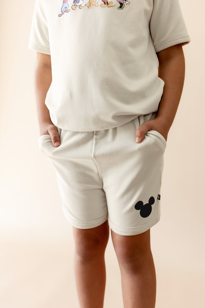 Close up on the shorts of the mickey and friends ecru set