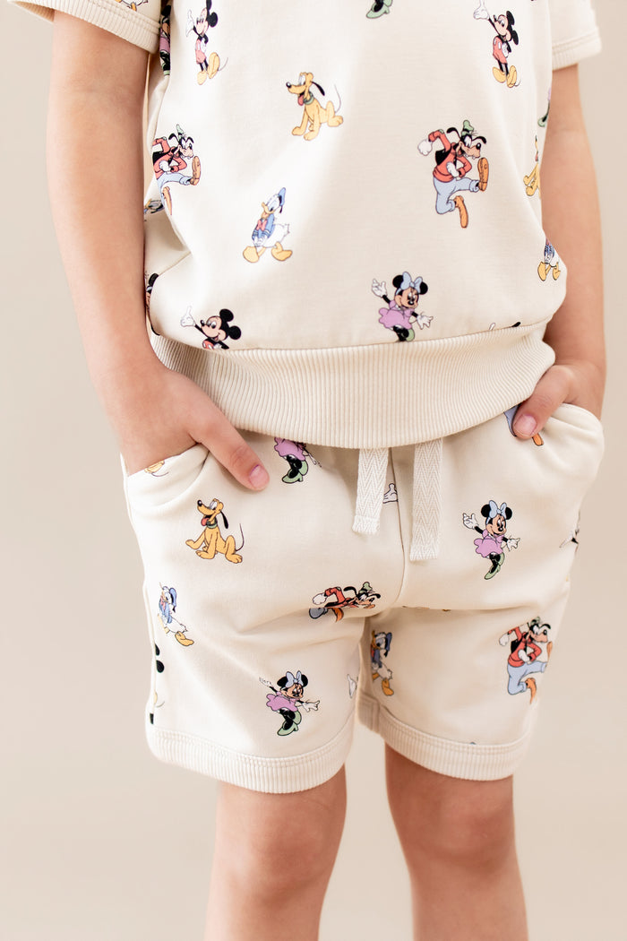Close up on the details of the matching mickey and friends patterned set with adjustable drawstring and pockets