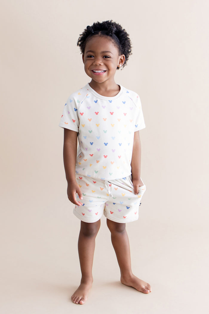 Toddler girl wearing matching shirt and short set with pastel mickey head pattern