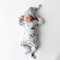 Sleeping newborn wearing the Take Me Home Set with Cap in Winnie the Pooh Hundred Acre Wood