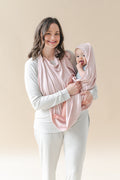 Mother holding her infant child wrapped in the Terry Apron Towel in Blush