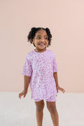 Child wearing Thistle Leopard print Toddler Biker Short set on a beige background