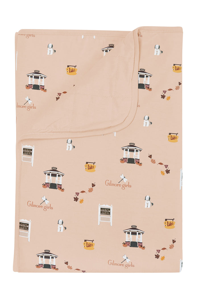Beige blanket with Gilmore Girls pattern on a white background