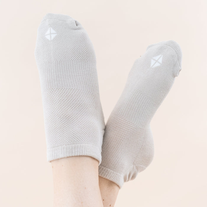 Woman wearing pair of Kyte Baby Women's Ankle Socks in Neutral