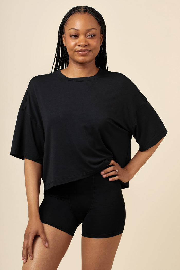 Woman wearing a black tee and boxer short