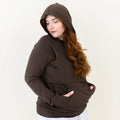 Smiling female wearing the Women's French Terry Nursing Hoodie in Espresso with the hood up and her hands in the kangaroo pocket