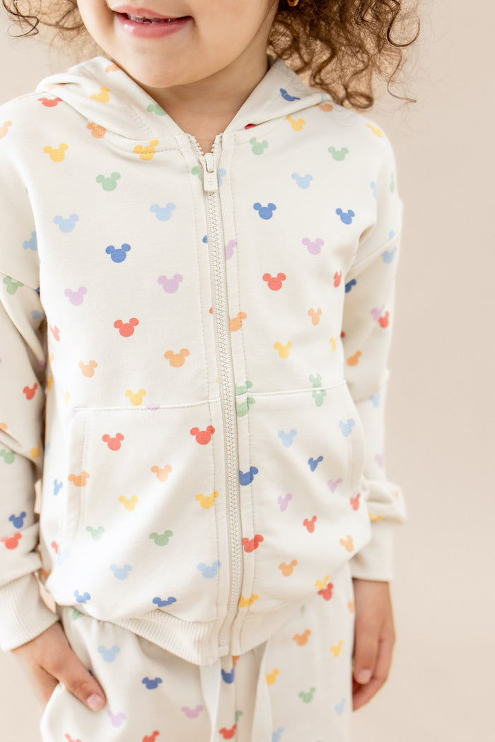 child in a zip up hoodie with mickey mouse head colorful pattern
