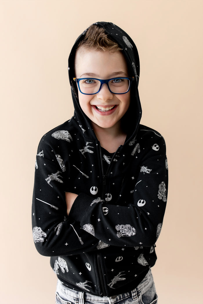 Young boy modeling the Zip-Up Hoodie in STAR WARS™ with the hood up
