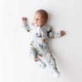 Sleeping newborn wearing the Zippered Footie in Winnie the Pooh Hundred Acre Wood